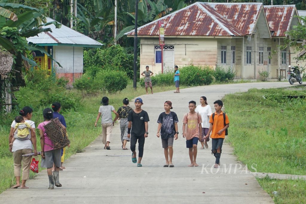 Remaja berjalan kaki di Dusun Rogdok, Desa Madobag, Kecamatan Siberut Selatan, kembali ke indekos dari kampung untuk sekolah di pusat kecamatan, Muara Siberut, Kepulauan Mentawai, Sumatera Barat, Minggu (31/7/2022) sore.