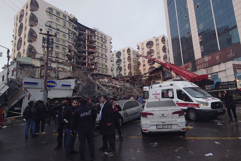 Rescue workers and medical teams try to reach trapped residents in a collapsed building following and earthquake in Diyarbakir, southeastern Turkey, early Monday, Feb. 6, 2023. A powerful earthquake has caused significant damage in southeast Turkey and Syria and many casualties are feared. Damage was reported across several Turkish provinces, and rescue teams were being sent from around the country. 