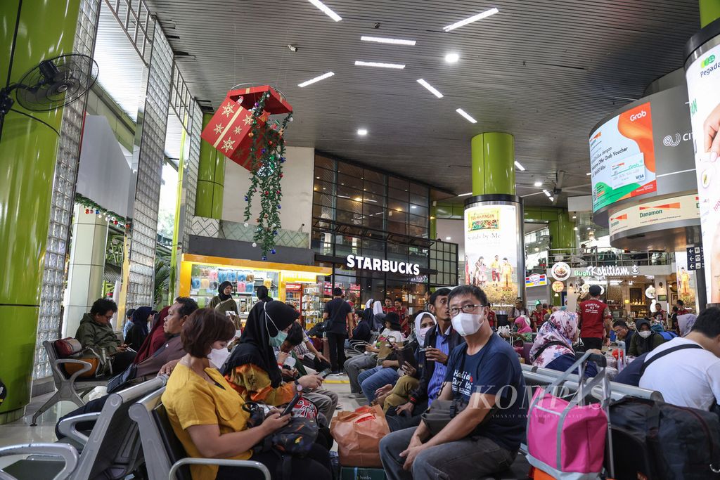 Warga menunggu jadwal pemberangkatan di Stasiun Gambir, Jakarta, Kamis (21/12/2023). Lebih dari 14.000 warga meninggalkan Jakarta melalui Stasiun Gambir pada 21 Desember 2023.  