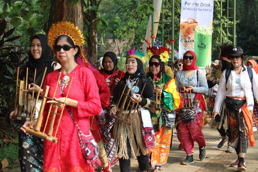 Sejumlah peserta membawa alat musik angklung saat Kirab Sedekah Hutan di kawasan Universitas Indonesia, Depok, Jawa Barat, Sabtu (3/6/2023). 
