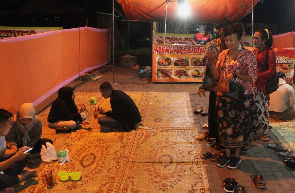 Transpuan mengamen di warung-warung lesehan di bawah Jembatan Layang Janti, DI Yogyakarta, Rabu (20/7/2022) malam. Sebagian transpuan pengamen di Yogyakarta sudah berusia di atas 60 tahun.