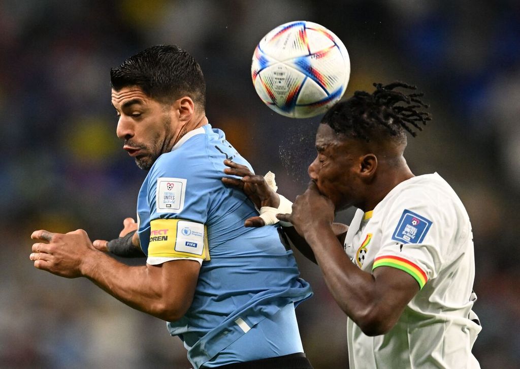 Penyerang Uruguay Luis Suarez dan bek Ghana Mohammed Salisu saling memperebutkan bola di udara dalam pertandingan Grup H Piala Dunia Qatar antara Ghana dan Uruguay di Stadion Al Janoub, Al Wakrah, Jumat (2/12/2022).