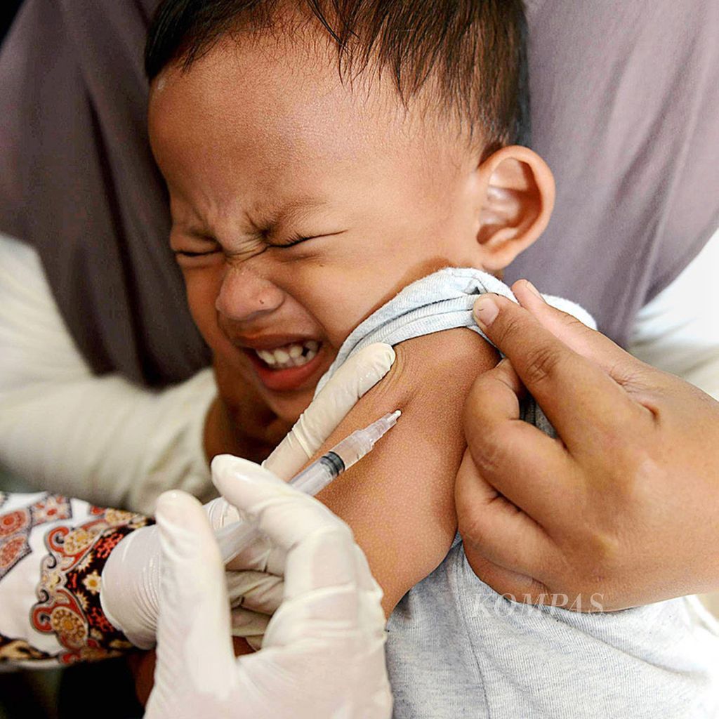 Seorang anak menahan sakit saat disuntik vaksin campak dan rubela (MR) saat berlangsung program imunisasi di posyandu Kelurahan Cinangka, Sawangan, Depok, Sabtu (23/9/2017).