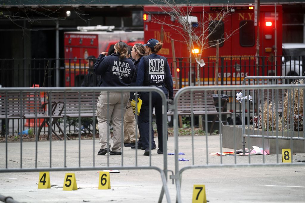 Para petugas kepolisian New York mengumpulkan bukti di sekitar taman di luar Pengadilan Kriminal Manhattan tempat seorang pria membakar dirinya pada Jumat sore tanggal 19 April 2024 di New York City. 