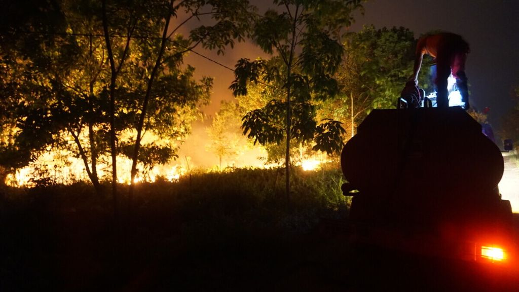 Petugas pemadam kebakaran menyiapkan peralatan saat memadamkan api di Kelurahan Sabaru, Kota Palangkaraya, Kalimantan Tengah, September 2019. Selama 24 jam penuh, para petugas pemadam kebakaran memantau dan memadamkan api, khususnya di lahan gambut.