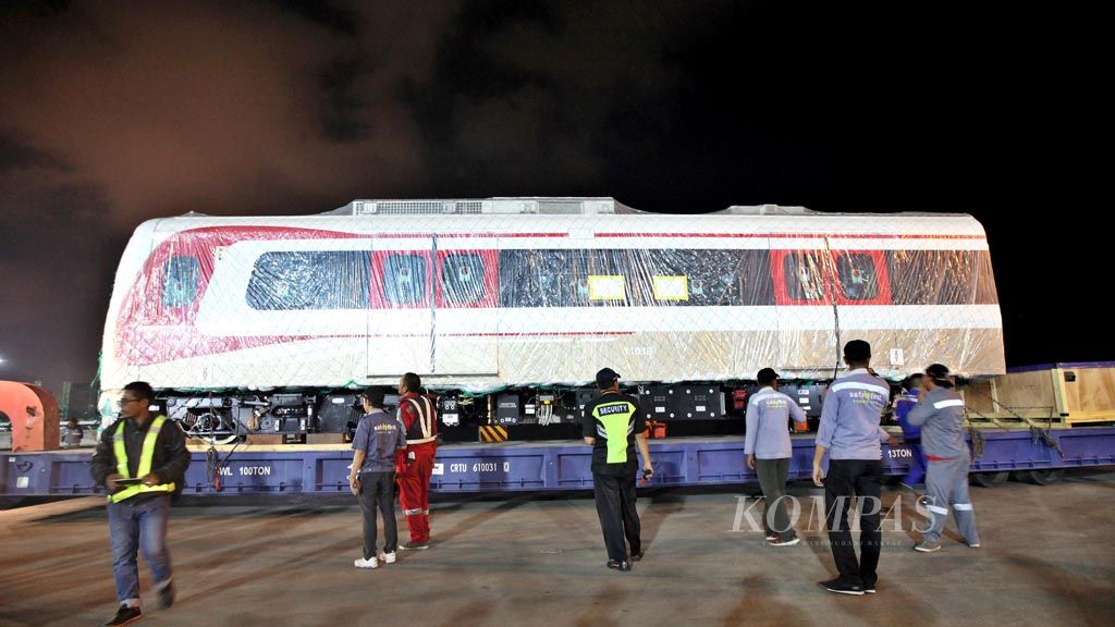A car for the Light Rail Transit (LRT) system is discharged at the vehicle terminal of Jakarta’s Tanjung Priok Port on Friday (13/4/2018) evening. It is part of the first of eight trains that will gradually arrive in Jakarta from Korea. The arrival will be followed by the preparation of trial operations to be conducted in May.