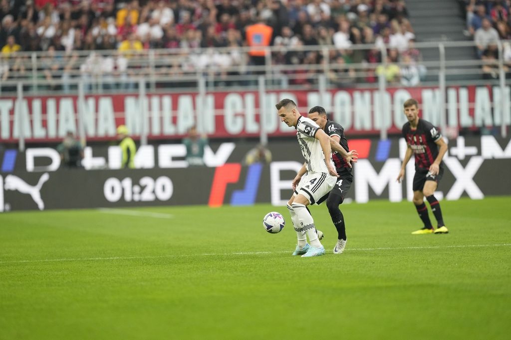 Pemain Juventus Arkadiusz Milik (kiri) dan pemain AC Milan Ismael Bennacer berebut bola pada laga Liga Italia di Stadion San Siro, Milan, Sabtu (8/10/2022). Milan menang 2-0 pada laga itu. 