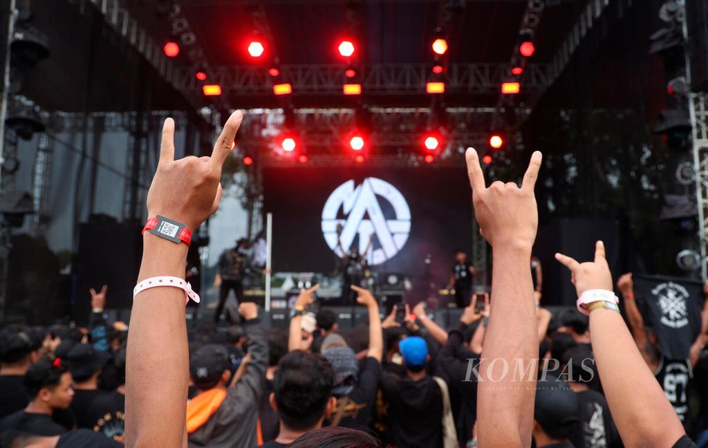 Acungan salam metal penonton saat menyambut band penampil pada Rock in Solo di Benteng Vastenburg, Surakarta, Jawa Tengah, Minggu (10/12/2023). 