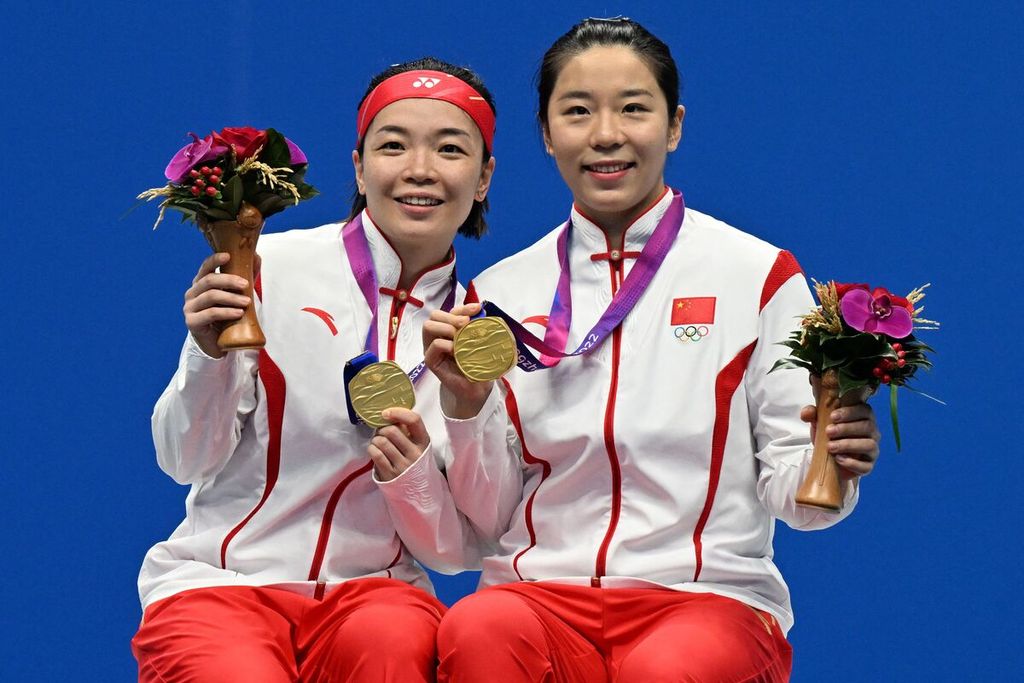 Peraih medali emas bulu tangkis ganda putri Asian Games Hangzhou 2022, Chen Qingchen (kiri) dan Jia Yifan, berpose bersama usai upacara penyerahan medali di Binjiang Gymnasium Hangzhou, Sabtu (7/10/2023). 