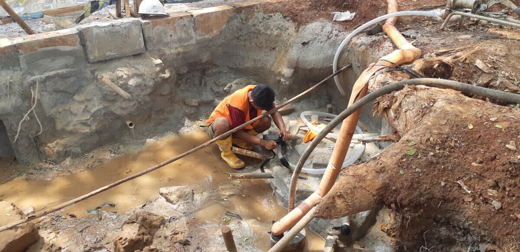 Pekerja di proyek perbaikan kebocoran pipa air bersih milik Perusahaan Umum Tirta Jaya II di Tebet, Jakarta Selatan, Selasa (8/1/2019).