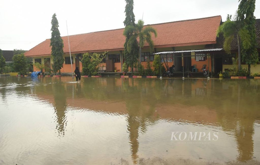 Ilustrasi: Banjir luapan Kali Lamong menggenang halaman sebuah sekolah di Kecamatan Benjeng, Kabupaten Gresik, Jumat (11/2/2022). 