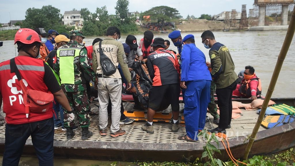 Ilustrasi. Petugas mengangkat jenazah korban kecelakaan terbaliknya perahu penyeberangan di Sungai Bengawan Solo, Desa Ngadirejo, Kecamatan Rengel, Kabupaten Tuban, Jawa Timur, Kamis (4/11/2021). 