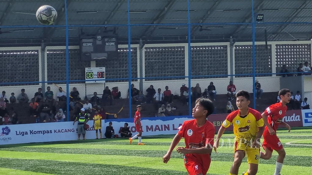 Pemain Buperta Cibubur (kiri) dan pemain Salfas Soccer mengamati bola di udara pada laga pekan keempat Liga Kompas Kacang Garuda U-14, Minggu (17/12/2023), di Lapangan Dewantara, Tangerang Selatan, Banten. Pada laga itu, Salfas menang, 1-0.