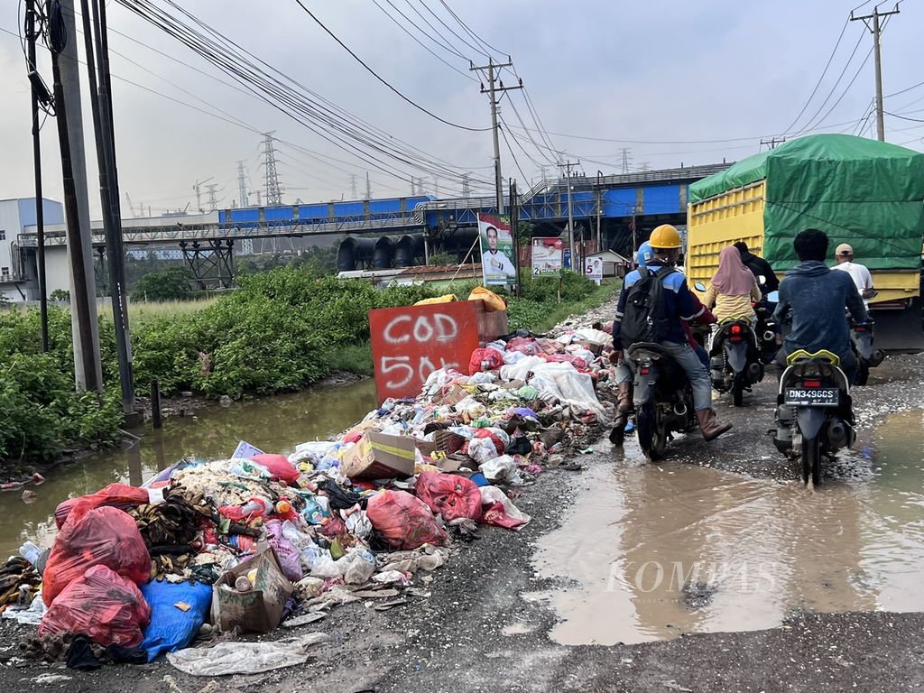 Salah satu sisi Jalan Trans-Sulawesi di Kecamatan Bahodopi, Morowali, Sulawesi Tengah, Jumat (29/12/2023). Tumpukan sampah seperti ini mudah dijumpai di tepi jalan.