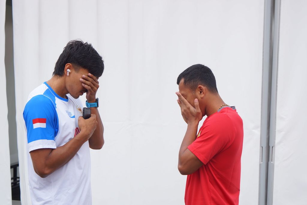 Pelari Wahyu Setiawan (kiri) dan Adit Rico berdoa sebelum bertanding  di Dong’an Lake Sports Park Aquatics Center, Chengdu, Selasa (1/8/2023).