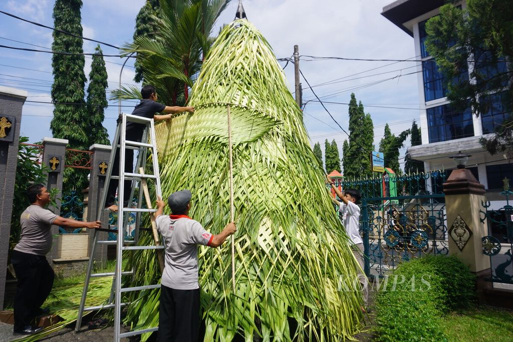 Umat menyiapkan pohon natal berbahan janur di halaman Gereja Katedral Kristus Raja Purwokerto, Kabupaten Banyumas, Jawa Tengah, Kamis (21/12/2023).