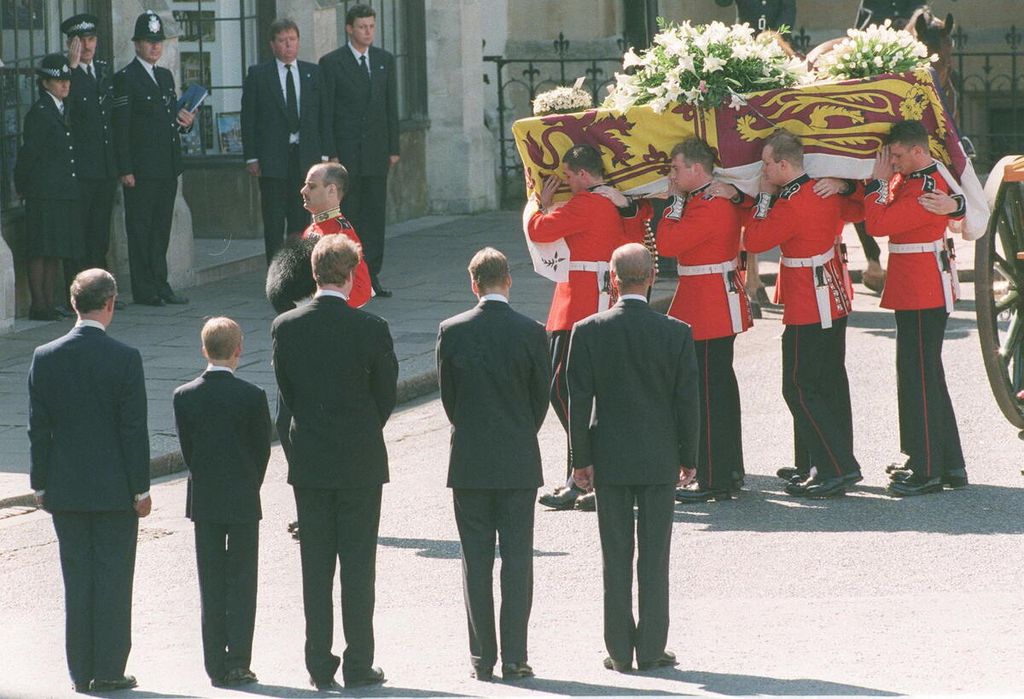 Foto yang diambil pada tanggal 6 September 1997 ini memperlihatkan Pangeran Charles (kiri, membelakangi kamera), Pangeran Harry (kedua dari kir), dan Pangeran William (ketiga dari kiri) menyaksikan peti jenazah Putri Diana yang dibawa ke Westminster Abbey, London, Inggris. 