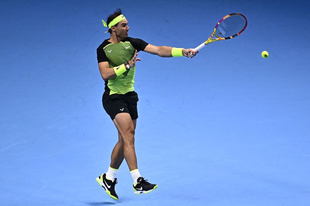 Petenis Spanyol Rafael Nadal memukul bola dalam pertandingan melawan petenis Kanada Felix Auger-Aliassime pada pertandingan penyisihan grup Final ATP di Turin, Italia, Selasa (15/11/2022). Auger-Aliassime menang 6-3, 6-4. 
