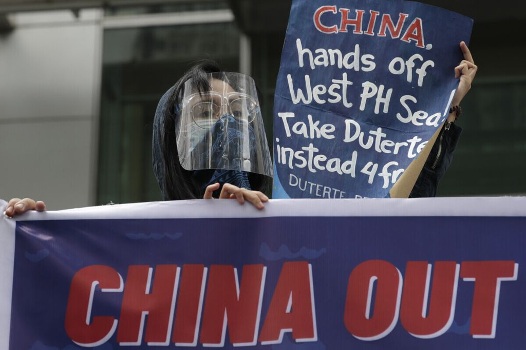 Protesters hold slogans during a rally outside the Chinese consulate in Metro Manila, Philippines on Friday, May 7, 2021. The group is demanding China to get out of Philippine-claimed territory in the South China Sea.