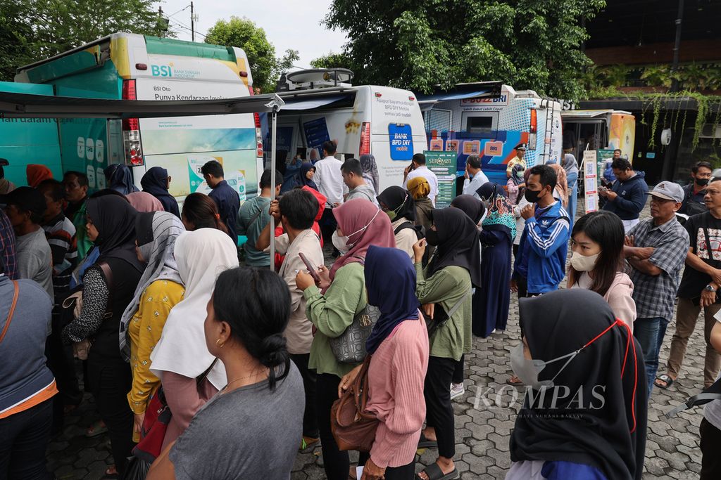 Warga antre untuk mendapatkan layanan penukaran uang di depan Pura Pakualaman, Yogyakarta, Senin (25/3/2024). 