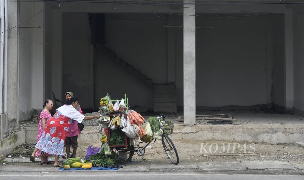 Penjual sayur keliling melayani pelanggan di Tarakan, Kalimantan Utara, Senin (18/7/2022). Sektor informal memberikan peran krusial bagi perekonomian. Jumlah pekerja informal di Indonesia meningkat pesat pada awal pandemi Covid-19. 