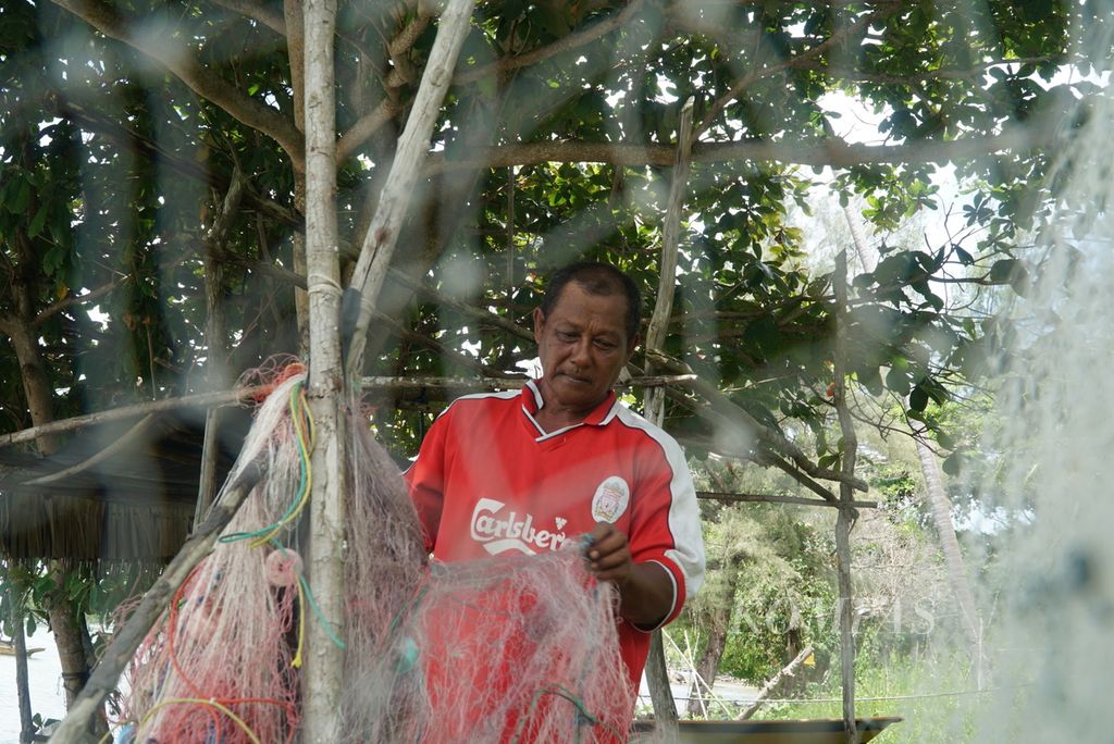 A fisherman is tidying up his net in Pasir Panjang Village, Rempang Island, Batam City, Riau Islands, on Tuesday (19/9/2023).