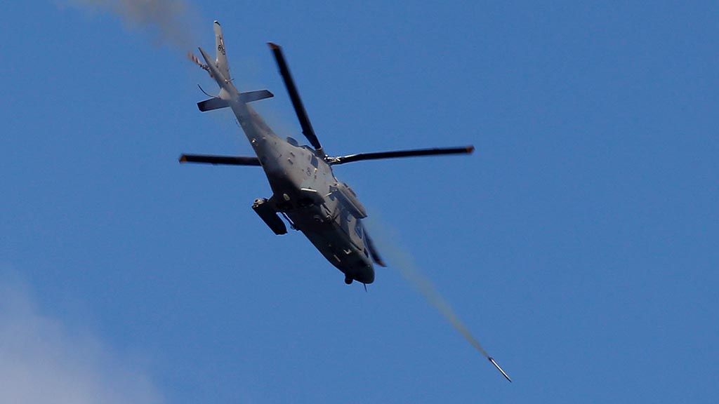 A helicopter gunship fires a rocket at Muslim militant positions in the continuing assaults to retake control of some areas of Marawi city Sunday, May 28, 2017 in southern Philippines. Philippine forces launched fresh airstrikes Sunday to drive out militants linked to the Islamic State group after days of fighting left corpses in the streets and hundreds of civilians begging for rescue from a besieged southern city. 