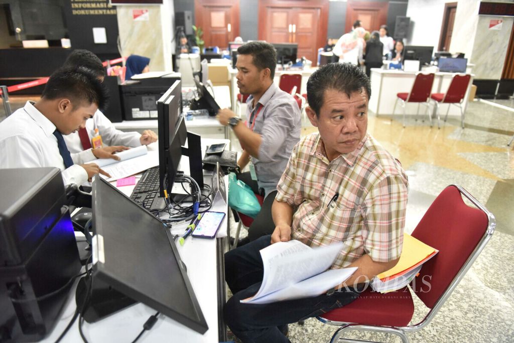 Petugas melayani perwakilan Partai Golkar yang menyetorkan bukti tambahan dalam gugatan sengketa perselisihan hasil pemilhan umum (PHPU) 2019 di lobi utama gedung Mahkamah Konstitusi (MK), Jakarta, Selasa (11/6/2019). 