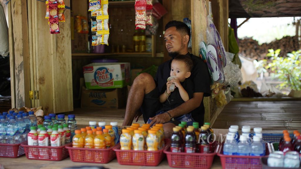 Dani menunggu pembeli di teras warungnya di Kampung Legok Jeruk, Desa Kanekes, Kecamatan Leuwidamar, Kabupaten Lebak, Banten, Kamis (16/3/2023). Kampung itu baru saja dibuka empat bulan lalu. Hanya ada lima kepala keluarga yang tinggal di sana. 