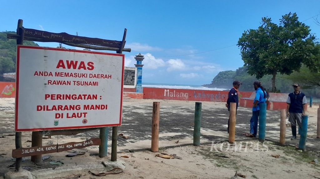Imbauan larangan berenang terpampang di Pantai Jembatan Panjang, Desa Sumberbening, Kecamatan Bantur, Kabupaten Malang, Jawa Timur, Minggu (9/7/2023). Pada saat bersamaan, kegiatan pencarian dan penyelamatan tiga dari lima korban terseret ombak sehari sebelumnya tengah dilaksanakan.