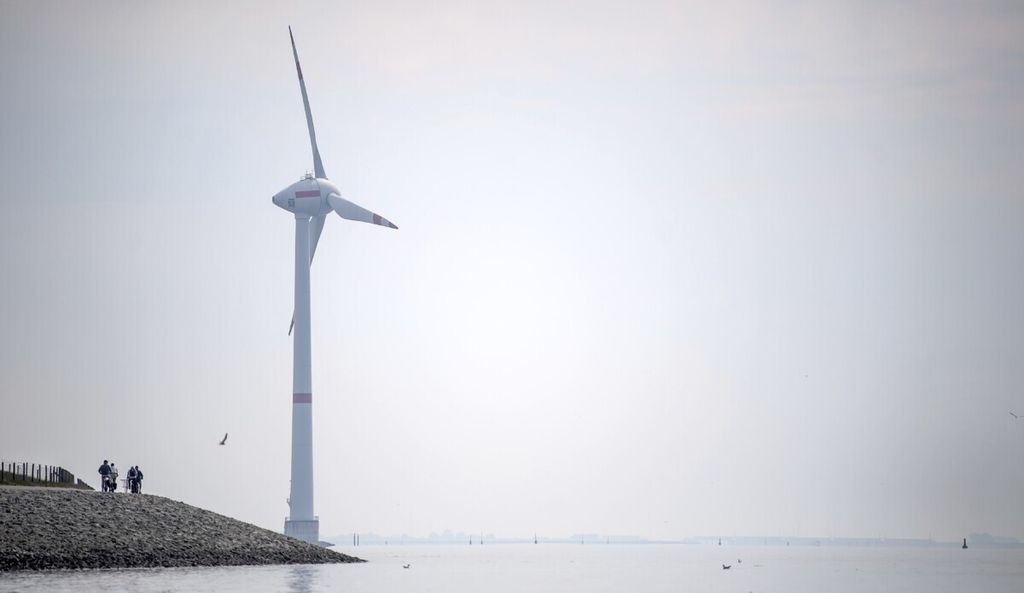 Cyclists ride along the dyke in Emden, Germany, Wednesday, June 3, 2020. The German government wants to increase offshore wind power capacity five-fold by 2040 as part of its plan to wean the country off fossil fuels. Cabinet on Wednesday agreed a bill that would set a goal of 40 Gigawatts of installed offshore wind power capacity in 20 years, from about 7.5 Gigawatts at present. It also raised the target for 2030 from 15 Gigawatts to 20. 