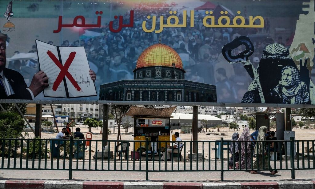 A picture taken on June 16, 2019, shows a poster in Gaza City denouncing the US Middle East peace plan dubbed the "deal of the century". - Arabic writing on poster reads "The deal of the century will not pass".