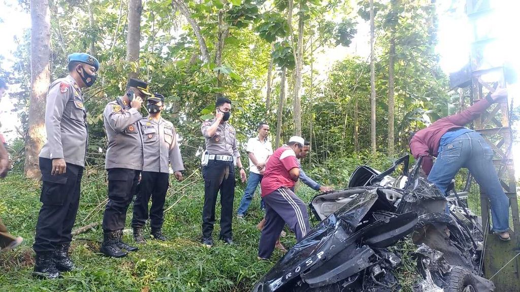 Aparat Kepolisiab Resor Pesawaran mengecek kondisi minibus yang tertabrak kereta api di Kecamatan Tegineneng, Kabupaten Pesawaran, Lampung, Rabu (14/9/2022).