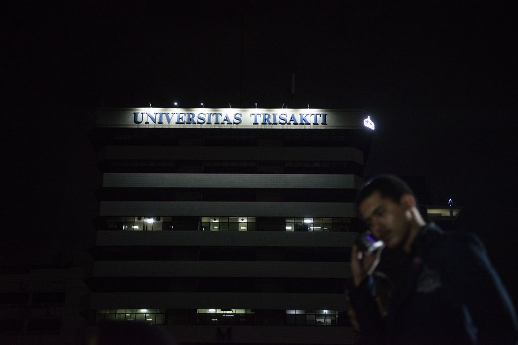 A student makes a call at Trisakti University on Thursday (11/5/2023). The annual Gelora Night serves as a reminder of the tragedy of the killing of four Trisakti University students on May 12, 1998. Trisakti University, as one of the private higher education institutions, is planned to convert its status to a state university with legal entity.