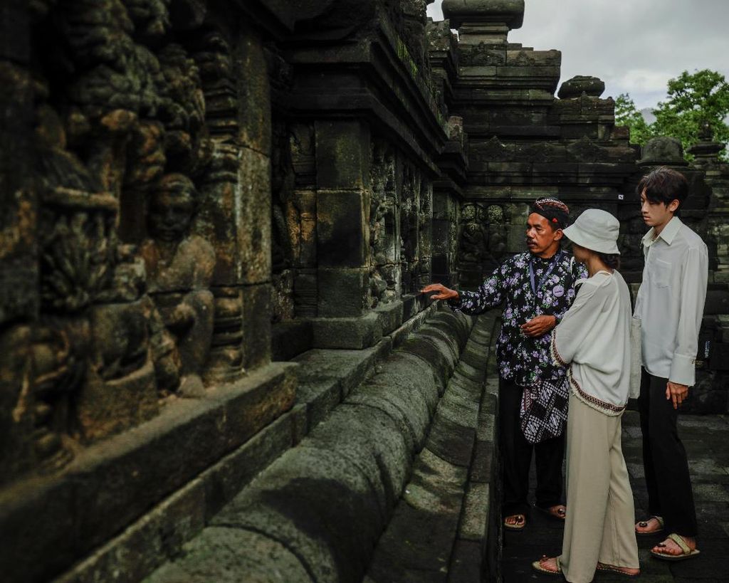 Sejumlah pengunjung yang naik ke bangunan Candi Borobudur bisa berjalan-jalan dan mendapatkan penjelasan perihal relief candi dari pemandu wisata, seperti terlihat pada Kamis (2/3/2023).