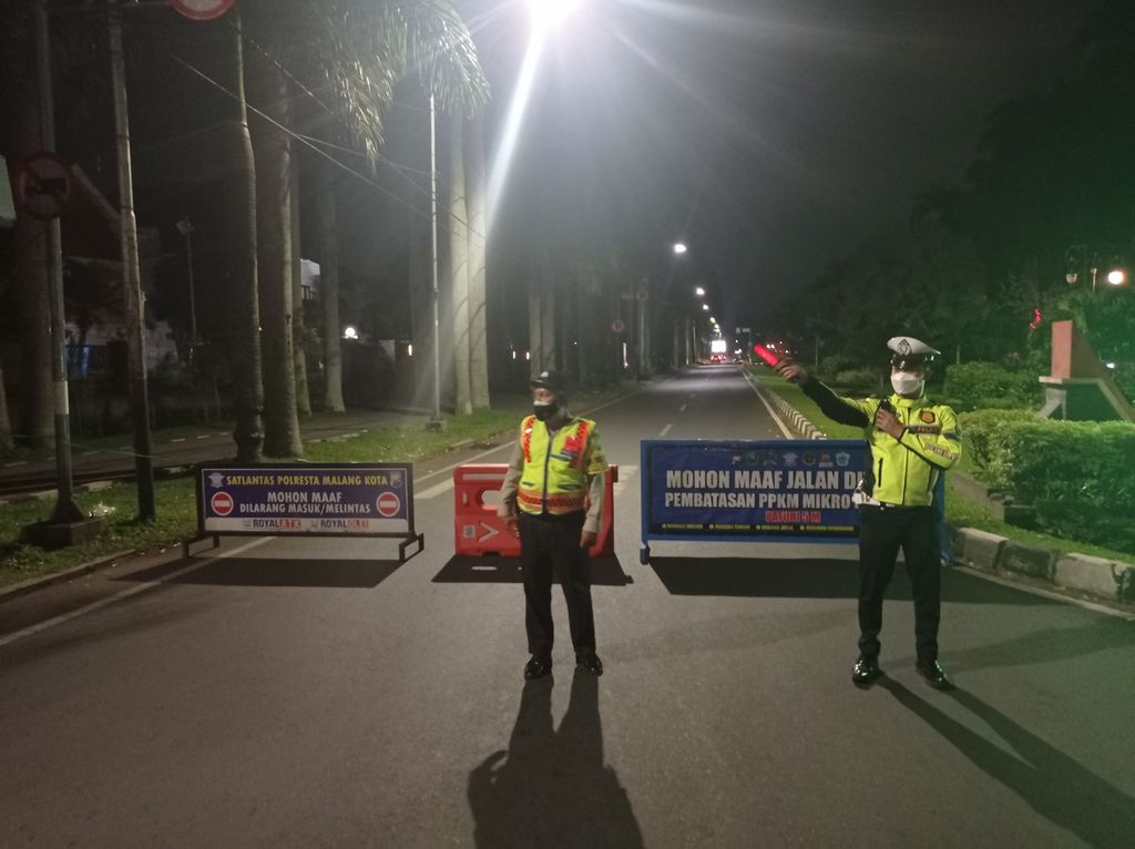 Petugas menutup Jalan Ijen saat malam pertama PPKM Darurat Kota Malang, Jawa Timur, Sabtu (3/7/2021). 