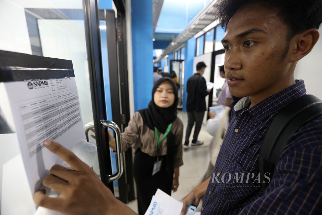 Peserta memeriksa daftar nama sebelum memasuki ruang Ujian Tulis Berbasis Komputer (UTBK) di Kampus A Universitas Negeri Jakarta (UNJ) Rawamangun, Jakarta, Senin (8/5/2023). 