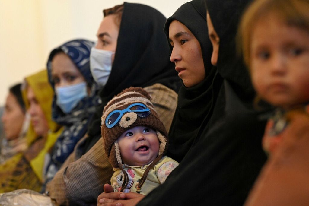 A Hazara woman carried her child while attending the International Women's Day event in Bamiyan Province, Afghanistan on March 8th, 2021.