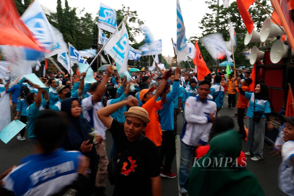 Pengunjuk rasa dari serikat buruh yang berjoget saat mereka berunjuk rasa menuntut kenaikan upah di Jalan Pahlawan, Kota Semarang, Jawa Tengah, Kamis (30/11/2023). 