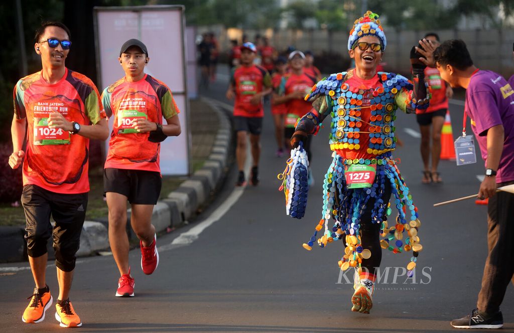 Officers encourage Bank Jateng Friendship Run runners as they pass through the Taman Mini Indonesia Indah area, Jakarta, on Sunday (11/9/2022).