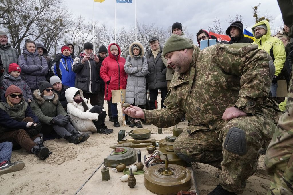 Seorang instruktur (kanan) memperlihatkan granat saat melatih para anggota kelompok sayap kanan Ukraina di Kiev, Ukraina, 20 Februari 2022. 