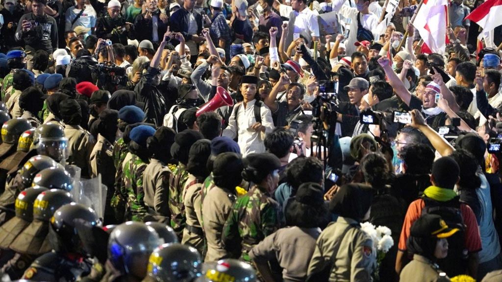 Para petugas polisi berjaga-jaga hingga para peserta aksi menolak hasil Pemilu 2019 di depan Kantor Bawaslu RI, Jakarta, membubarkan diri, Selasa (21/5/2019). Aksi yang diberi waktu toleransi polisi ini akhirnya membubarkan diri dengan tertib.