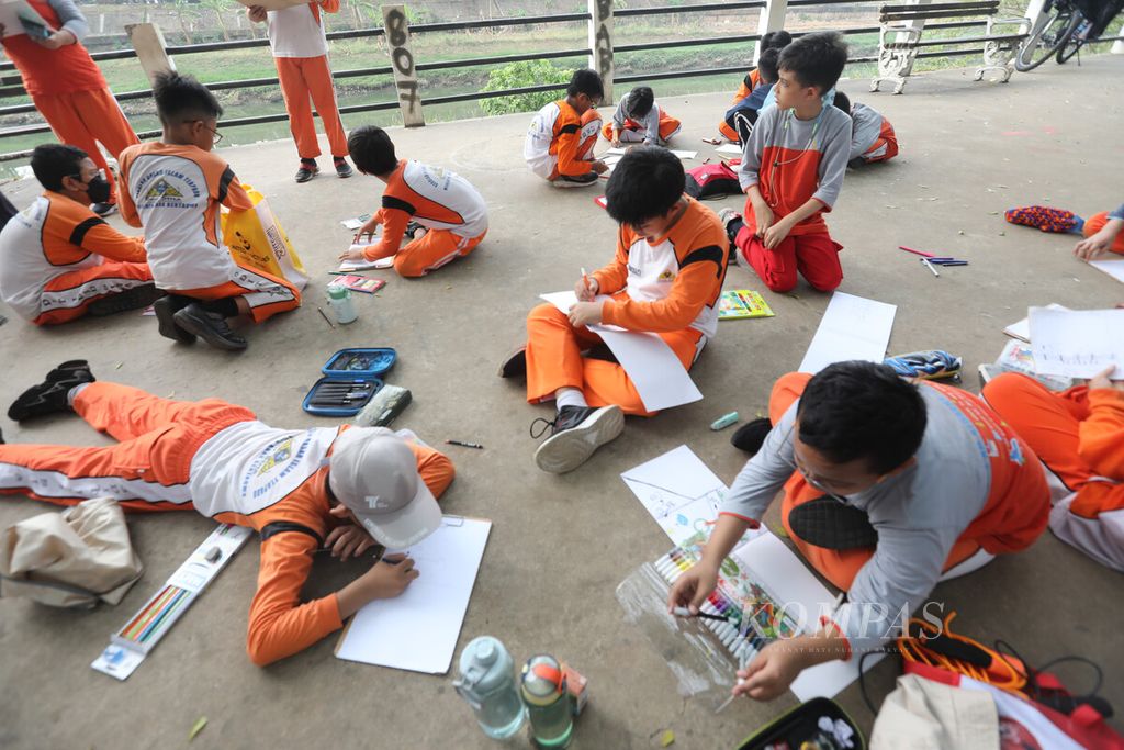 Siswa SDIT Ibnu Sina Duren Sawit, Jakarta Timur, mengikuti kegiatan belajar luar sekolah dengan menggambar di jalur inspeksi Kanal Banjir Timur, Kamis (9/11/2023). Para orangtua berjuang keras untuk mendapatkan sekolah terbaik bagi anak-anaknya.