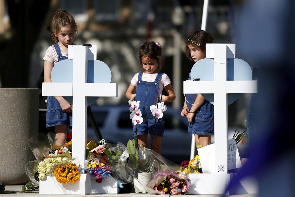 Anak-anak pada Kamis (26/5/2022), memberikan penghormatan di lokasi peringatan korban penembakan massal di Sekolah Dasar Robb di Kota Uvalde, Texas, Amerika Serikat.  