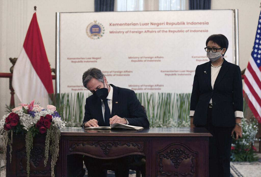 U.S. Secretary of State Antony Blinken signs the guest book as Indonesian Foreign Minister Retno Marsudi looks on at the Pancasila Building in Jakarta Tuesday, Dec. 14, 2021. (Olivier Douliery/Pool Photo via AP)
