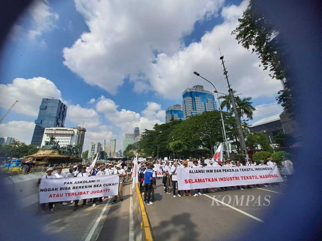 Ratusan orang dari industri kecil menengah tekstil dan produk tekstil serta buruh sektor ini berunjuk rasa di depan Patung Arjuna Wijaya, Jalan Medan Merdeka Barat, Jakarta Pusat, Kamis (27/6/2024). Mereka menuntut pemerintah mengendalikan impor tekstil dan produk tekstil.