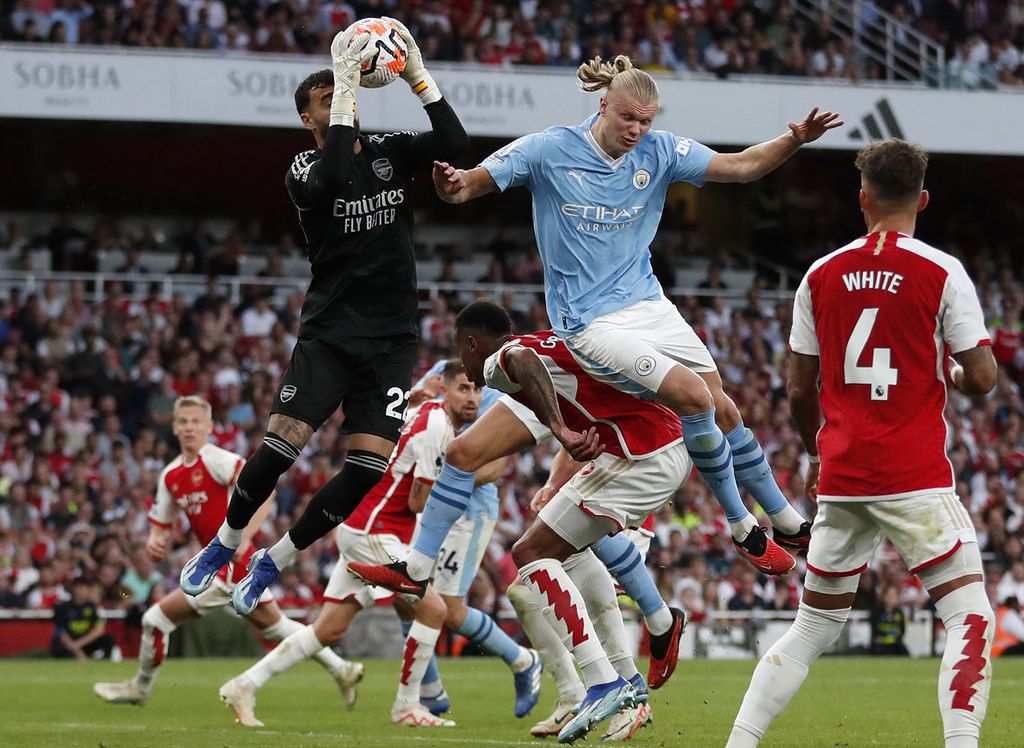 Arsenal goalkeeper David Raya caught the ball under pressure from Manchester City striker Erling Haaland during a Premier League match at the Emirates Stadium in London on October 8, 2023. The two teams will face each other again in a crucial match at City's home ground on Sunday, March 31, 2024.