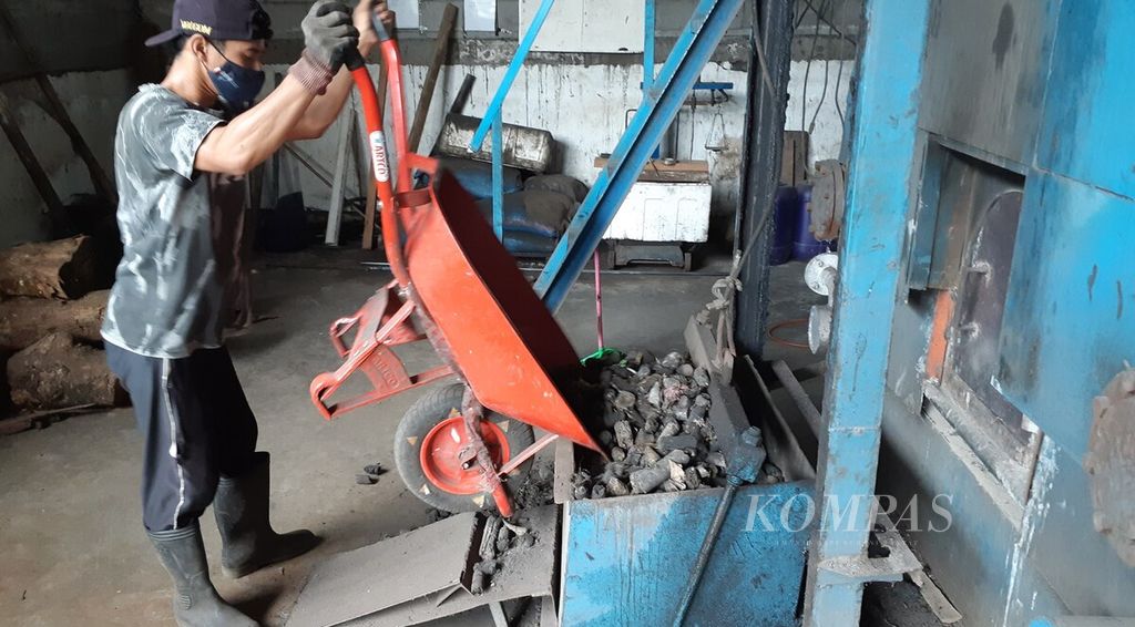 Pekerja di PT Kemasan Ciptatama Sempurna, Kota Denpasar, menuangkan briket sampah RDF ke mesin pembakaran, Jumat (8/4/2022). Briket sampah RDF menjadi contoh pemanfaatan produk dari bahan baku sampah sebagai bahan bakar alternatif. 