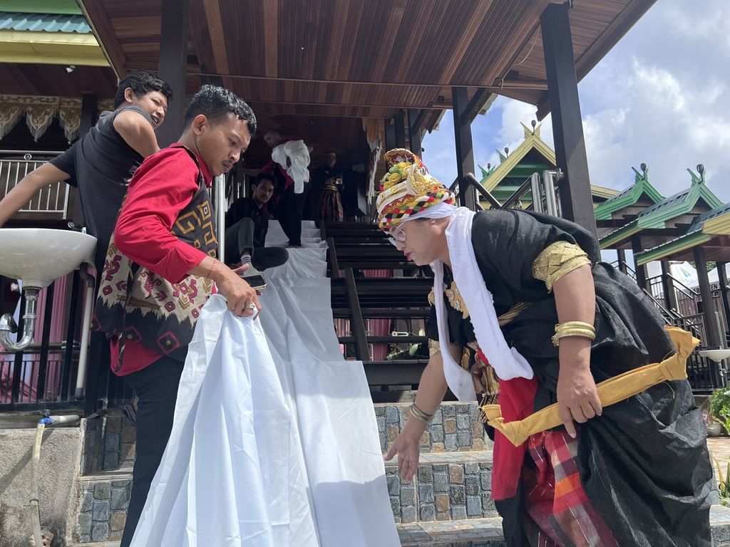 Bissu Ancu mengarahkan para penjemput tamu dan mengatur berbagai persiapan dalam sebuah hajatan pernikahan adat di Soppeng, Sulawesi Selatan, Minggu (17/7/2022).