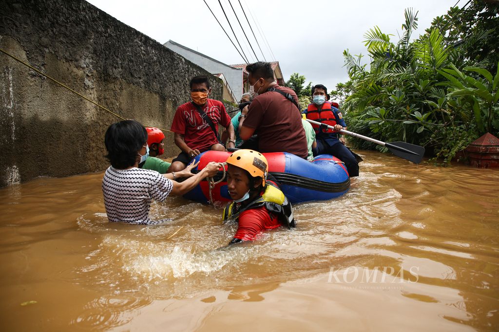 Officers evacuate residents from their flooded houses at the IKPN Complex, Bintaro, Pesanggrahan, South Jakarta, on Saturday (20/2/2021).